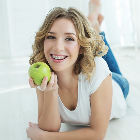 Woman with adult orthodontics sharing smile