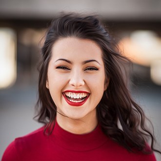 Woman with flawless smile after adult orthodontic treatment