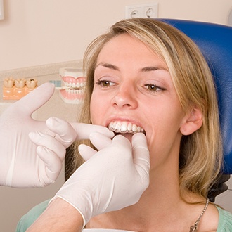 Orthodontist checking fit of Invisalign tray