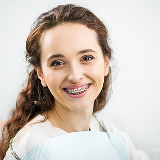 a patient with braces smiling in Dayville