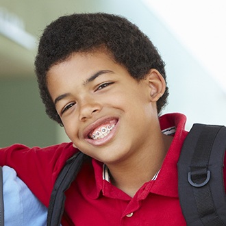 Young boy smiling during pediatric orthodontics