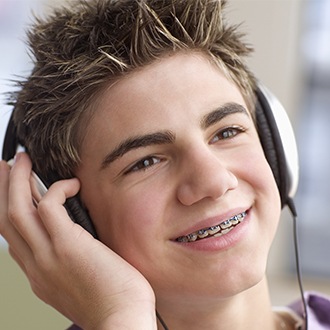 Preteen boy with pediatric orthodontics smiling