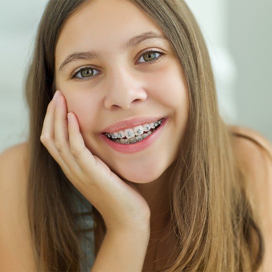 Teen girl smiling with self ligating braces