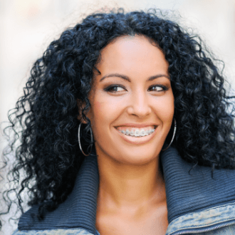 Woman smiling during clear braces treatment