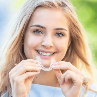 Young woman placing Invisalign tray