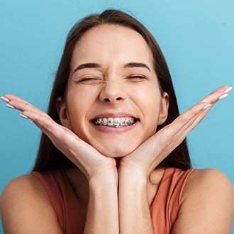 Woman showing off smile with braces