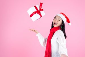 Smiling woman with gift and braces in Dayville