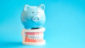 Dayville orthodontist blue piggy bank on top of model teeth