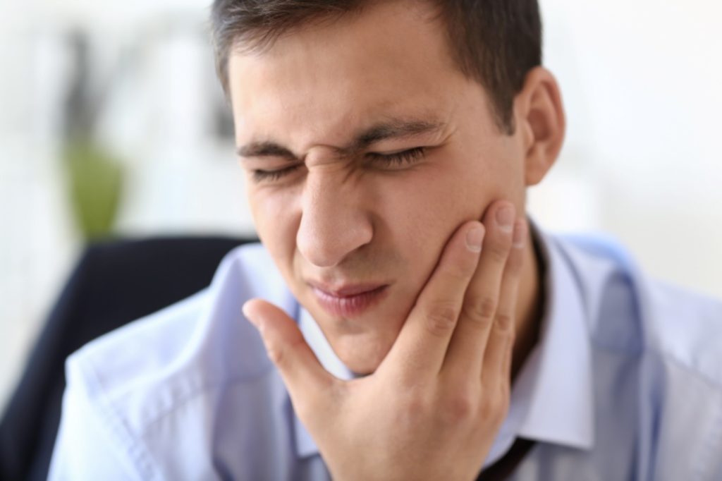 Closeup of man experiencing tooth pain