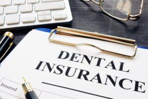 Dental insurance paperwork on clipboard for orthodontic treatment