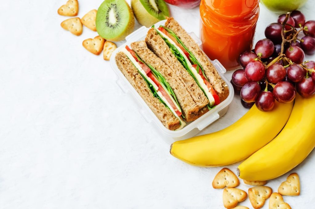 Closeup of sandwich, grapes, and a banana 