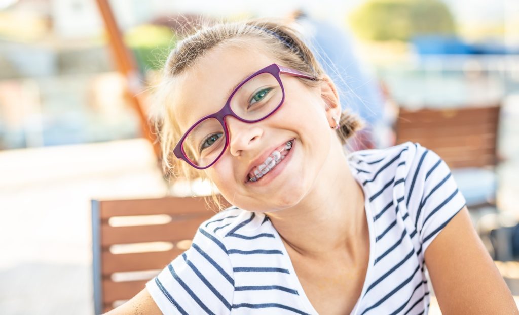 Closeup of young girl with braces smiling