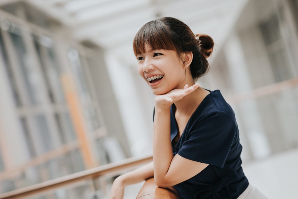 Woman with braces smiling while running errands